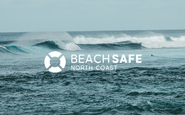 Beach Safe North Coast Logo on an image of waves of the Atlantic Ocean with a person ready to surf.