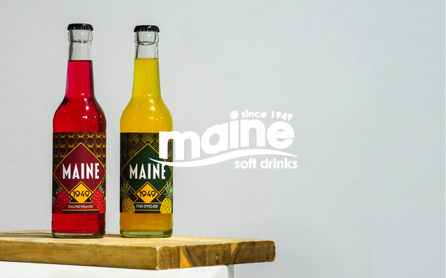 Maine Soft Drinks Logo on a photograph of vibrant coloured bottles of soft drinks with custom package design.