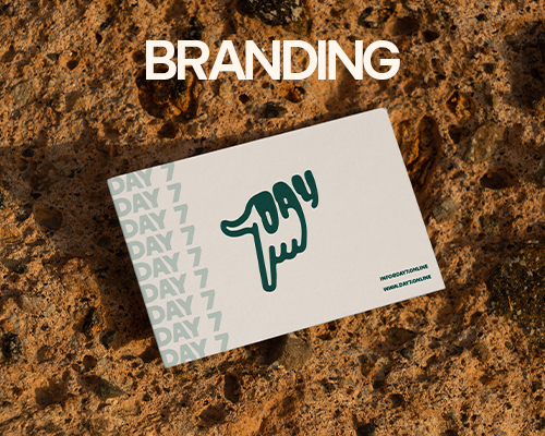 A business card on a rocky surface. The text title is branding.